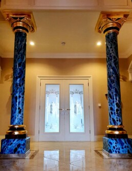 Hand painted blue marble, 24ct gold leaf gilded capitals with a red leather faux finish inlay.