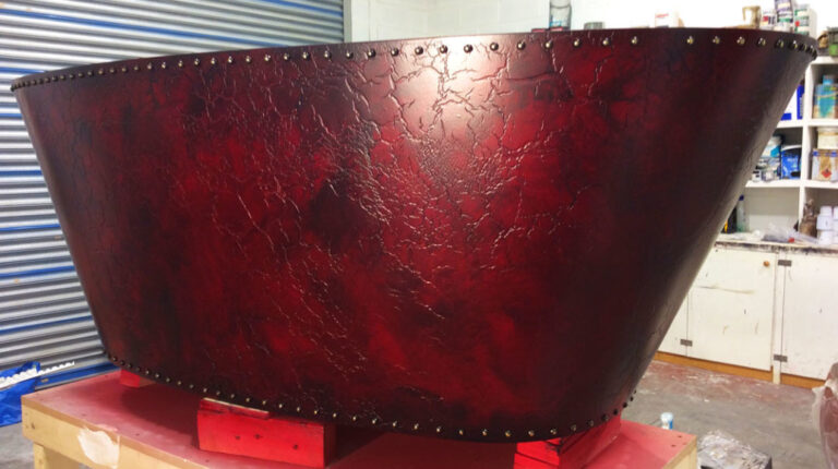 This bespoke and authentic cracked red leather bath finish was created as part of a collection of exclusive bath finishes.